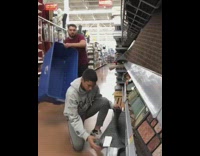 Prank guy puts blue plastic container over friends head