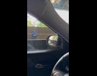 Man ride bike opposite direction of traffic