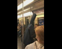 Tall cello case on subway train