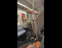 Man struggles to move grey couch alone on train