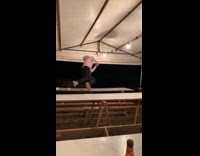 Guy jumps on bodyslams and breaks white bench table in half under white tent then runs away