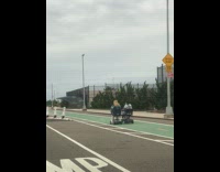 Two ladies ride mobility scooter on highway
