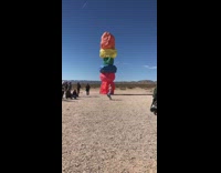 Woman white top dance colorful stacked boulders
