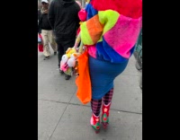 Woman wears colorful outfit walks on street