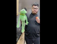 Man Feeds and Throws Kermit the Puppet