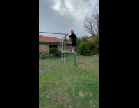 Boy backflips on backyard playground fell down
