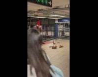 Brown living statue guy has photoshoot at subway station