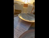 Woman white dress photoshoot front of filmer