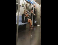 Tall guy does bicep curls with dumbbells on subway train