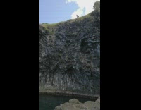 man jumps off black asphalt cliff