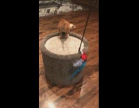 Orange kitten plays blue feather stick toy