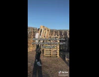 Collab BSMedia - Guys stack wooden pallets high for bonfire