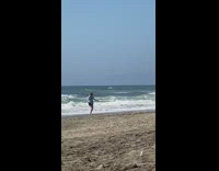 White shirt girl spins slowly beach guy