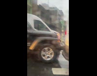 Black car stuck on the white van at road in NYC 