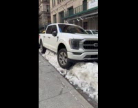 Pickup truck on top of snow pile