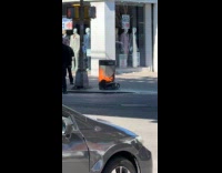 Trash bin with blazing fire at sidewalk