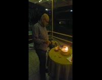 Dad claps hands over cake birthday candle 