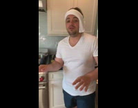 Guy shows food he is making kitchen 