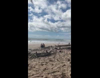 Woman with cap yoga poses at beach Part 2