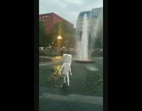 Person in white costume walking through fountain water