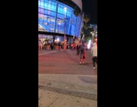 Collab IITW - Man in white jacket hoodie rap video shoot on the sidewalk