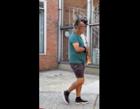 Man walk and carry dog on shoulder