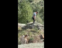 Guy does yoga pose on rock 