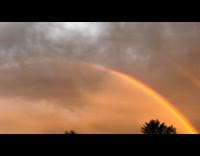 Double rainbow arc at sunset after storm