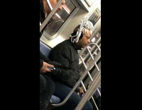 man on subway with silver tinfoil hair