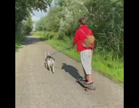 Girl rides skateboard walks dog blue leash