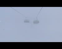 Thick fog chairlift snowboarding mountain  limited visibility