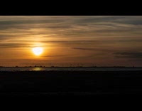 Time lapse of sunset and windmills