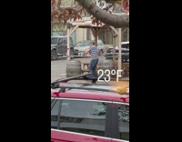 Man striped shirt dance beside barrels street