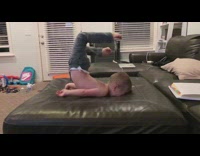Kid faceplants into couch while trying to jump on