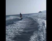Guy in red shorts tries to flip while wakeboarding ends up falling 