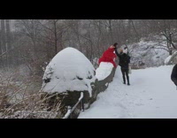 Girl wears red dress outside during snowstorm 