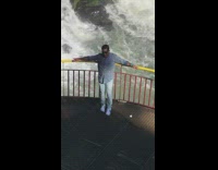 Blue button up shirt waterfall yellow handrail 