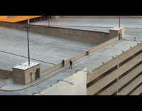 Two guys rooftop parking see security leave