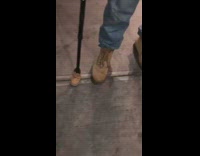 Guy matches timberland boots with black cane 