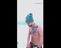 Shirtless guy cuts hair outside in snow