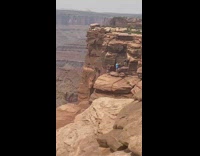 Three guys own selfie stand mountain cliff 