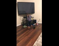 Little girl cleaning TV stand dancing to rap music