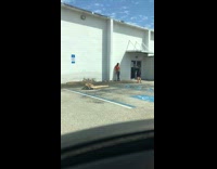 Man lift orange shirt wall parking lot