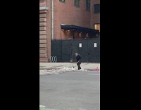 Guy holding sledgehammer hits snow on ground