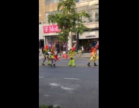 Group traffic cone head walk middle street