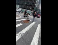 Man puts traffic cone at open sewer