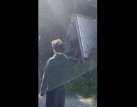 Grey sweater guy poses metal triangle grass 