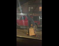 Man Skates on Street with Ski Poles
