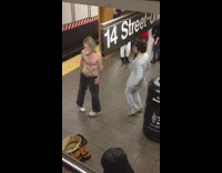 Shirtless man and guy in suit dance together in subway station