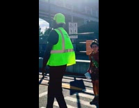 Pedestrian safety officer sing while on work 